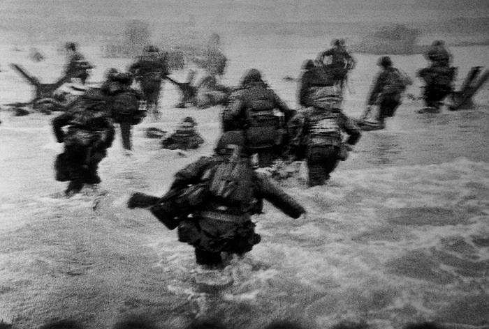 Robert Capa, US troops assault Omaha Beach during the D-Day landings, Normandy, France, June 6, 1944.  Robert Capa International Center of Photography/Magnum Photos