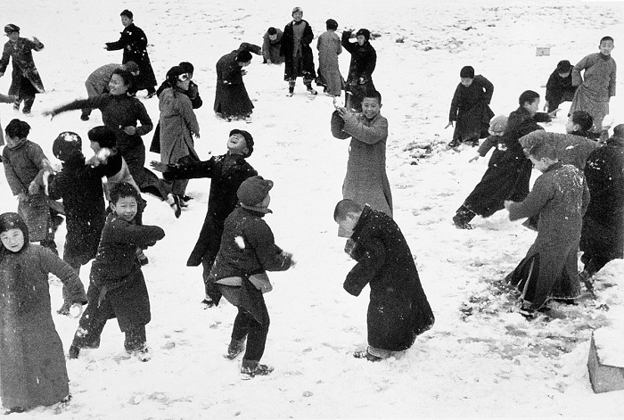 Robert Capa, Children playing in the snow, Hankou, China, March 1938.  Robert Capa International Center of Photography/Magnum Photos