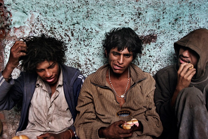 Valerio Bispuri, Lima, Perù, 2006. Ragazzi di strada mangiano dopo aver fumato paco. © Valerio Bispuri