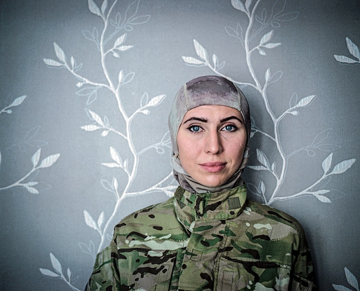 Justyna Mielnikiewicz, Odessa, Ukraine, July 2015.  Justyna Mielnikiewicz. Amina Okuyeva poses for the photo in a flat she shares with her mother and
son. She was on Maidan from December 2014 working as a medical
volunteer. In that time her husband was in prison accused of the attempt to kill
Russian President Putin. After Euromaidan revolution he was pardoned and
together with Amina joined international peacekeeping battalion of volunteers
to support Ukraine in fighting against the pro-Russian insurgency